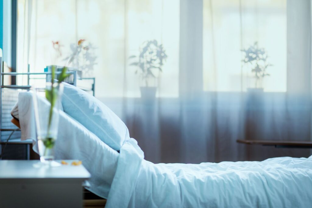 A hospital bed near a window with soft lighting in Houston, TX