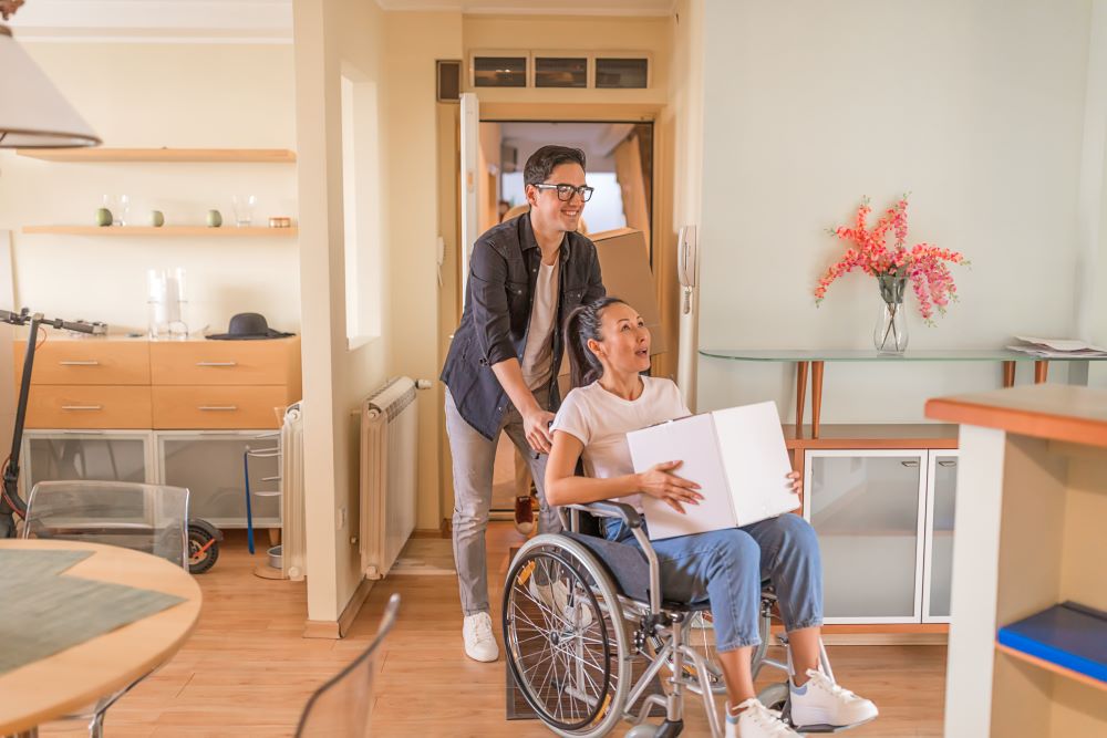 A happy woman in a wheelchair receiving a package in Houston, TX